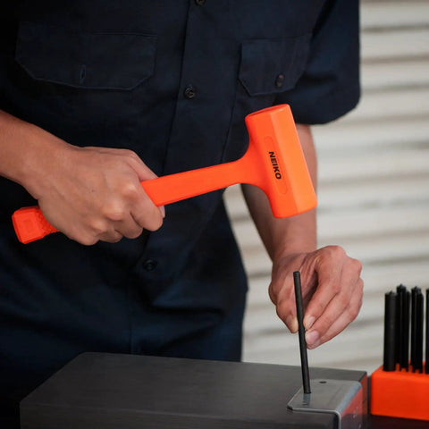 Person using 1 Lb Neon Orange Dead Blow Hammer With Unibody Molded Body And Checkered Grip, Spark And Rebound Resistant