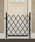 Badass Expandable Folding Security Gate 51 By 36 Inch Black Rugged Steel Diamond Grid Door closed at entrance.