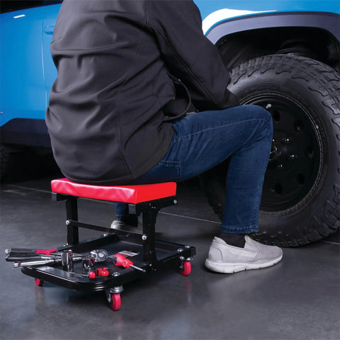 Person using Foldable C Frame Creeper Rolling Work Seat With Tool Tray For Mechanics In Garages And Shops Black Red 12 And A Half Inch Height