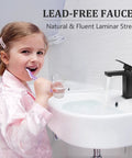 Child brushing teeth beside Matte Black Bathroom Faucet With Solid Brass Construction Single Lever Vanity Faucet Lead Free