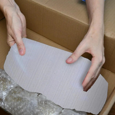 Hands hold a white foam pouch, part of 100 Pack White EPE Foam Packing Pouches For Fragile Items Protection With Space Saving Design.