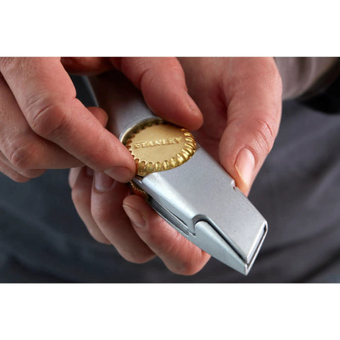 Person demonstrating the safe locking nose on Titan 1-10-550 Fixed Blade Utility Knife with silver handle