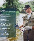 Man using Heavy-Duty Double-Side Magnetic Fishing Kit With 2200 Lb Pull Power by a river, holding magnet and rope, wearing gloves.