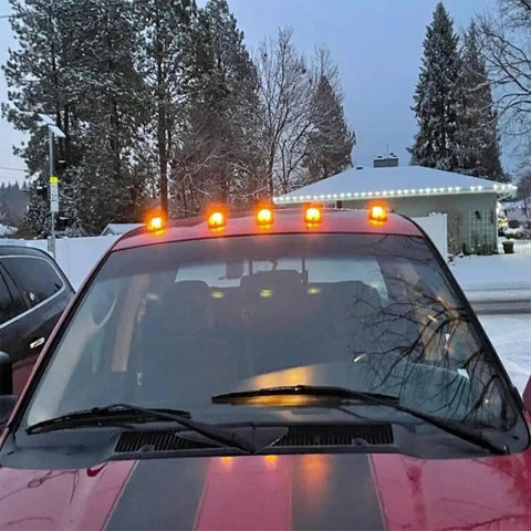 Truck with Upgrade Solar Cab Lights For Trucks No Drill Roof LED Marker Lights glowing on snowy evening