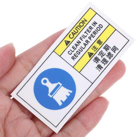 Factory Grade Industrial Equipment Maintenance Warning Sticker With PET Material held in hand, showing caution and cleaning symbols.