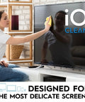Person using Screen Cleaner Spray 16 Oz All In One Cleaning Kit For LCD LED OLED TVs Smartphones Tablets Laptops Monitors And Other Devices Includes Microfiber Cloth Wipes And Dual Nozzle Bottles For Fast Smudge Free Shine on a TV screen.