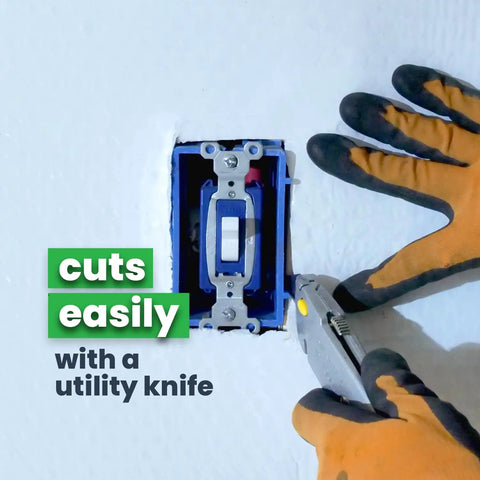 Cutting Double Bubble Reflective Foil Insulation Roll 48 X 75 Feet with a utility knife for easy installation.