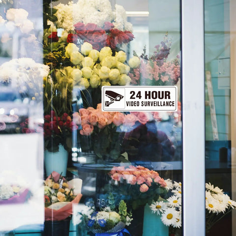 24 Hour Video Surveillance Sign 9x3 Inch Aluminum Silver Self Adhesive Metal Door Wall Sign Waterproof on flower shop window.