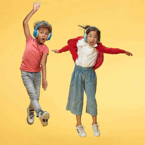 Kids jumping while wearing kid friendly noise canceling headphones for concentration and hearing protection, bright blue.