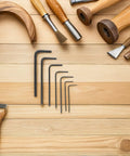 Super Cool Mini Metric Hex Key Set With Seven L Shaped Small Metal Wrenches For Furniture DIY Repairs Electronics And Precision Hand Tool Jobs That Fit Any Pocket Perfectly, seven black steel hex keys on wood