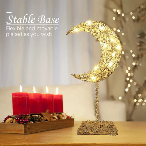 Moon Shaped Ramadan Desk Lamp Battery Powered With Warm White Led Wrought Iron Frame Cozy Bedside Nightstand Light For Christmas Decor And Vibe Home Bedroom Accent Romantic Soft Glow Silver showcasing warm glow next to red candles on table.