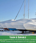 Top Shelf 7 Mil Polyethylene Shrink Wrap Roll For Boats And Jet Skis covering boats in snow, showcasing durable weatherproof marine storage.