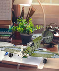 258 Piece Airplane Erector Set STEM Building Kit for Kids and Teens on a desk beside a clock and lamp