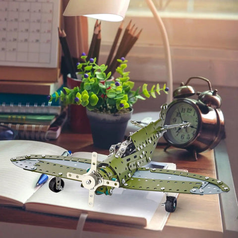 258 Piece Airplane Erector Set STEM Building Kit for Kids and Teens on a desk beside a clock and lamp