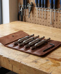 Beavorty Premium Steel And Carbide Tipped Electric Drill Pilot Bits For Cabinet Hinge Installations shown in a leather pouch on a workbench.
