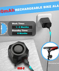 Rechargeable Bike Alarm With Remote, USB-C charging, 700mAh battery, wireless anti-theft system, shown charging on wall socket.