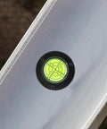 Bubble level close-up on an aluminum tool, part of 4pcs Acrylic Cylindrical Mini Spirit Level Tool for Precise Measuring.