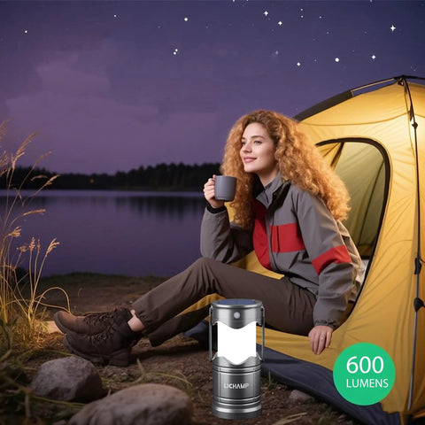 Woman sitting by a tent using Must Have 2 Pack Solar Camping Lanterns USB Rechargeable LED Lanterns, 600 lumens for camping.