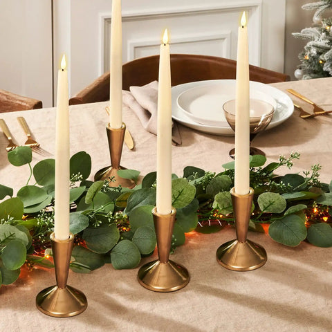 Flameless Taper Candles Set Of 4, 11 Inch Ivory Real Wax With 3D Wick Flame And Flickering LED, Remote Control And Timer on table.