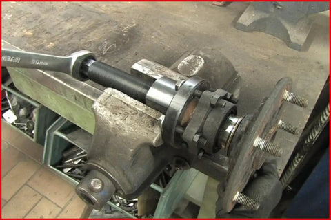 Close-up of Ford Transit Wheel Bearing Tool Kit, 17-Piece Pro Grade Set in use on a vehicle hub.