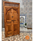 Rustic Dope Hand Carved Barn Door In Brown Finish For Interior Use Solid Wood Double Or Single Door Custom Size Made To Order Sliding Or Hinged Options Classic Farmhouse Look With No Glass Or Hardware Included, standing on tiled floor