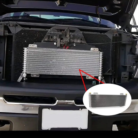 Transmission Oil Cooler With Mounting Hardware For 40K GVW Vehicles installed in front of vehicle grille, close-up view.