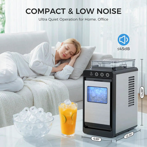 Countertop Portable Ice Maker With External Water Tank shown on table, glass of ice cubes and juice next to a sleeping person on sofa.