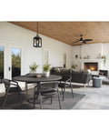 Porch Ready Farmhouse Outdoor Wall Lantern With Clear Glass Panes And Textured Black Finish hanging in a stylish outdoor patio.