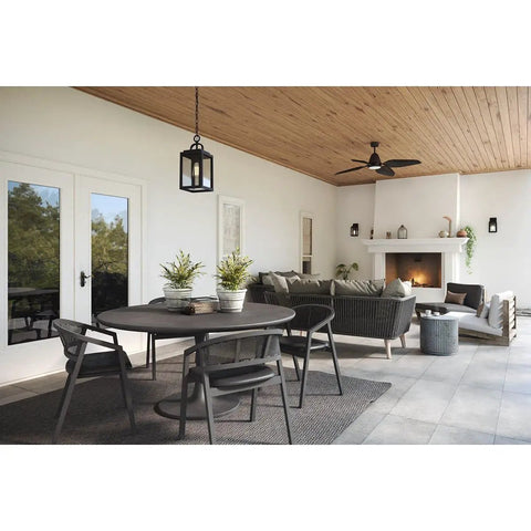 Porch Ready Farmhouse Outdoor Wall Lantern With Clear Glass Panes And Textured Black Finish hanging in a stylish outdoor patio.