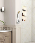 Three Arm Brushed Gold Folding Swivel Towel Hook Space Saving Metal Towel Holder For Bathroom Robe And Coat Also Perfect RV Organizer Screw Mount Smooth Fold Easy Install No Closet Needed visible on bathroom wall with towel.