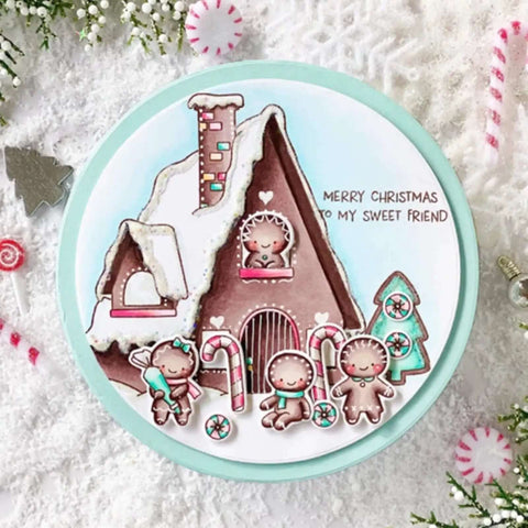 Christmas card featuring a gingerbread house and gingerbread figures with candy canes, snow, and the text 'Merry Christmas to my sweet friend'.