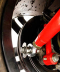 Rear Adjustable Toe Rod Kit With Spherical Rod Ends And Red Powder Coat For Chevy Camaro 2016 close-up of adjustable toe rod on suspension