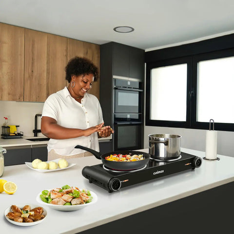 Woman using Dual Infrared 1800W Hot Plate Portable Electric Stove With Glass Cooktop And Adjustable Temperature Control Stainless Steel Double Burner