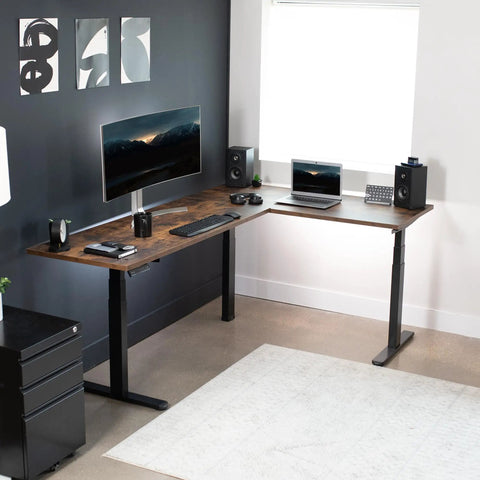 Electric Triple Motor Height Adjustable Corner Desk Frame For L Shaped Setup With 3 Legs Sit Stand Ergonomic Frame Up To 300 Lbs Black Frame Only DESK V130EB supporting an L-shaped desk with monitors and keyboard in a modern office setup.