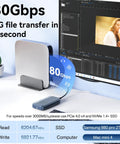 Badass M.2 NVMe SSD Enclosure With Smart Fan Cooling Supports Up To Eight TB Portable Drive on desk with computer, displaying 80Gbps speed.