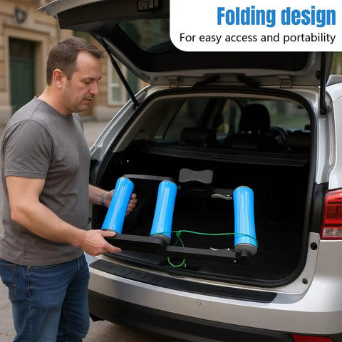 Person placing Whisper Quiet Indoor Bike Trainer With Foldable Stand into car trunk for easy storage and transport.