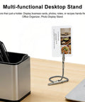 Multifunctional desktop stand holding a card next to a pen holder on a wooden desk.
