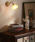 Premium Retro Wall Sconce Lighting French Copper Glass Led Indoor Outdoor Lamp Fixture Goes Along Perfectly Bedroom Living Room Bathroom Vanity Garden Upward Downward Glow Next Level Style Upgrade Two Pack glowing above a decorative surface with books and angel figurines.