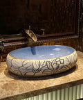 Bathroom Sinks Bathroom Vessel Sink Carved Lotus Art Countertop Basin with blue interior and floral design on a marble countertop.