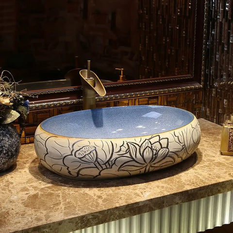 Bathroom Sinks Bathroom Vessel Sink Carved Lotus Art Countertop Basin with blue interior and floral design on a marble countertop.