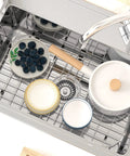 Stainless Steel Kitchen Sink Grid Protector For Bottom Of Sink 26 Inches Long By 14 Inches Wide With 4.9 Inch Center Drain Hole under dishes