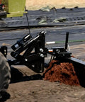 62 Inch Agricultural Landscape Rake With Tipper Latch And Spring Steel Tines clearing field debris while attached to ATV