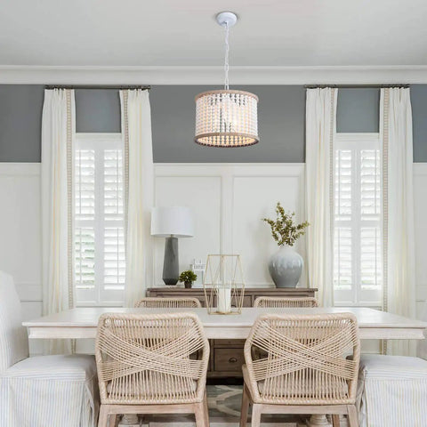 Dining room featuring Bohemian Wood Beaded Chandelier Three Light Pendant With White Finish over a wooden table.