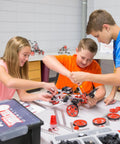 Kids collaborating on TETRIX Prime Max robot using Heavy Duty Kickass Aluminum 120 Degree Robot Gusset in STEM projects.