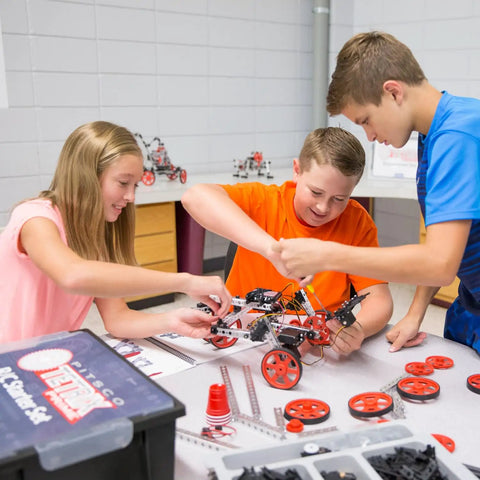 Kids collaborating on TETRIX Prime Max robot using Heavy Duty Kickass Aluminum 120 Degree Robot Gusset in STEM projects.