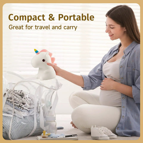 Pregnant woman placing Unicorn Night Light For Kids With Sound Machine, 16 Color Silicone Baby Night Lamp in travel bag.