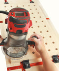 Woodworker using a CNC router on a table with a 4 Pack T Track Stop Block Set For Woodworking With Inline And Lateral Stops.