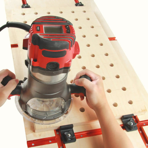 Woodworker using a CNC router on a table with a 4 Pack T Track Stop Block Set For Woodworking With Inline And Lateral Stops.