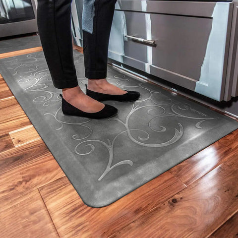 Person standing on Ergonomic Anti-Fatigue Floor Mat For Home Kitchen Garage And Office Standing Desks Polyurethane Water-Resistant Made In USA Bella Collection With Subtle Floral Design For All-Day Comfort