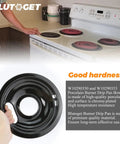 Person holding Porcelain Burner Drip Pan Bowls 2 Pack 8 Inch And 2 Pack 6 Inch Black Porcelain Electric Stove Drip Pans Fits Whirlpool Electric Ranges Mess Free And Spill Proof Replacement Set with stove in background